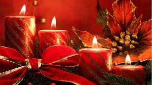 A Christmas image - red candles, a bow and pine cones
